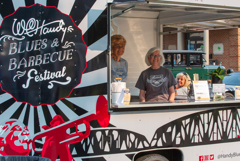 Photo of ladies working in a festival booth.